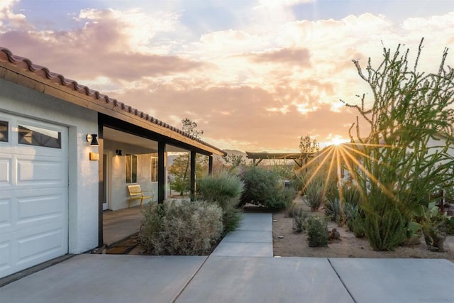 patio terrace at dusk with a garage