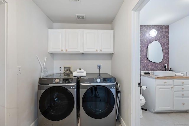 laundry area with washing machine and dryer and sink