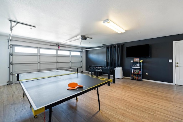 playroom featuring hardwood / wood-style floors and a textured ceiling