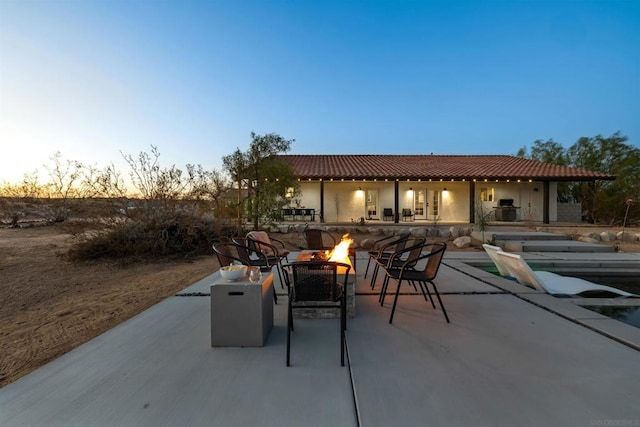 patio terrace at dusk with a fire pit