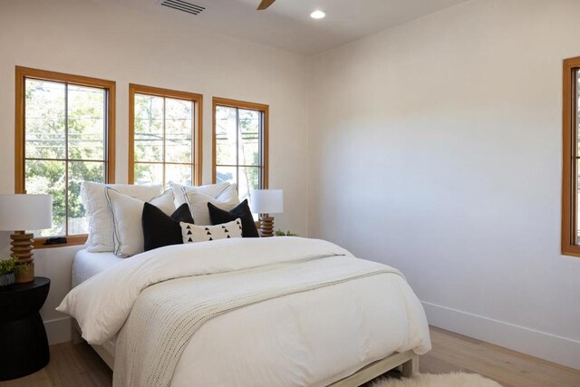 bedroom featuring light hardwood / wood-style flooring and ceiling fan