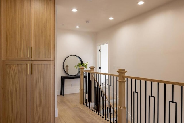 corridor with light hardwood / wood-style floors