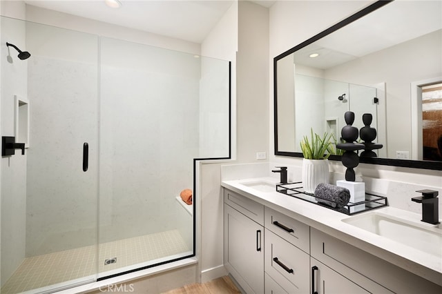 bathroom featuring vanity, wood-type flooring, and walk in shower