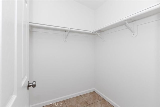 walk in closet featuring light tile patterned flooring