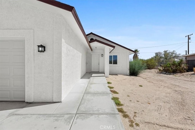 doorway to property featuring a garage