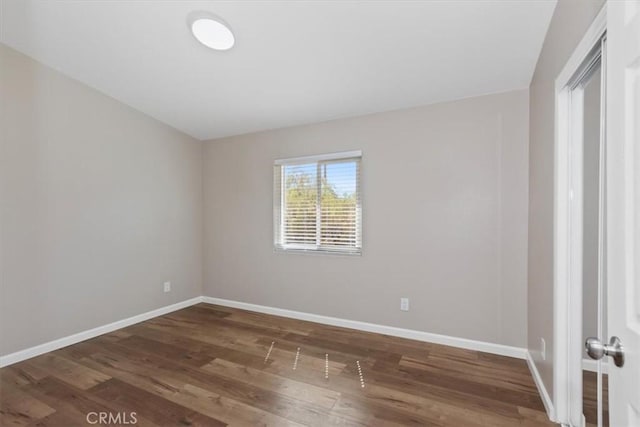 unfurnished room featuring dark hardwood / wood-style flooring