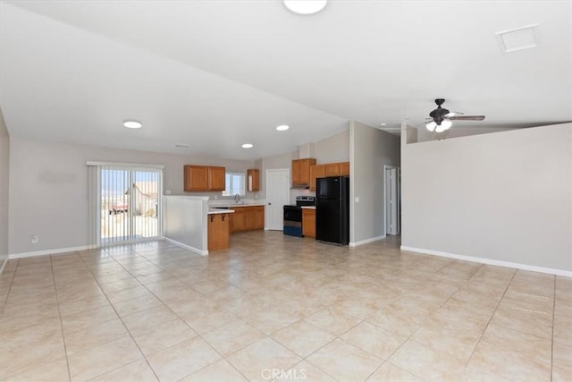 kitchen featuring stainless steel electric range oven, ceiling fan, sink, vaulted ceiling, and black refrigerator