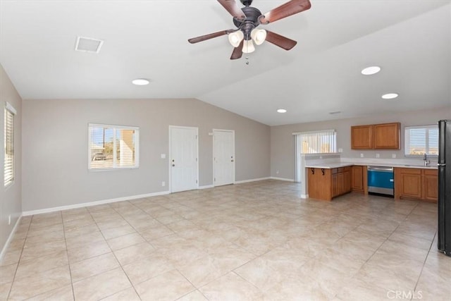 kitchen featuring kitchen peninsula, black refrigerator, stainless steel dishwasher, ceiling fan, and lofted ceiling