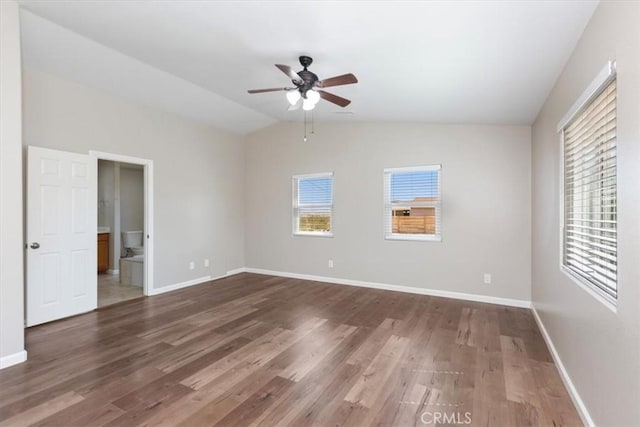 unfurnished bedroom featuring dark hardwood / wood-style flooring, ensuite bathroom, vaulted ceiling, and ceiling fan