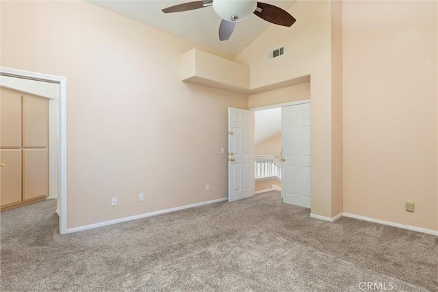 unfurnished bedroom featuring ceiling fan, light colored carpet, and high vaulted ceiling