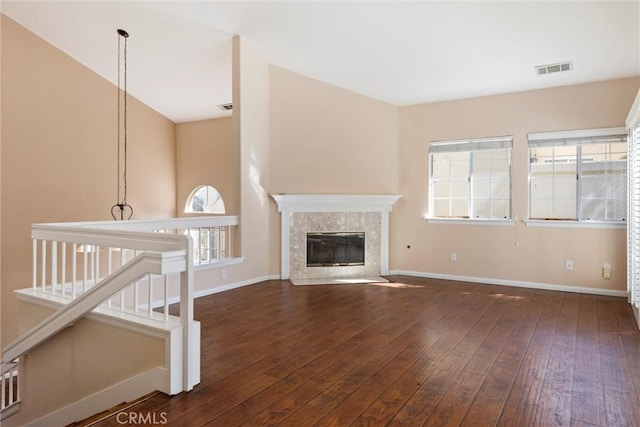 unfurnished living room featuring a fireplace and dark hardwood / wood-style flooring