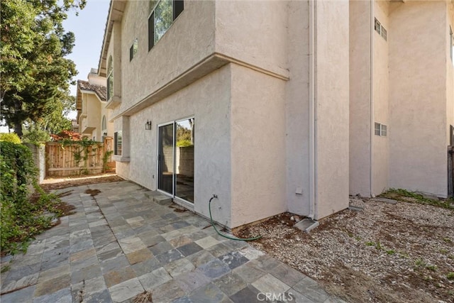 view of property exterior with a patio area