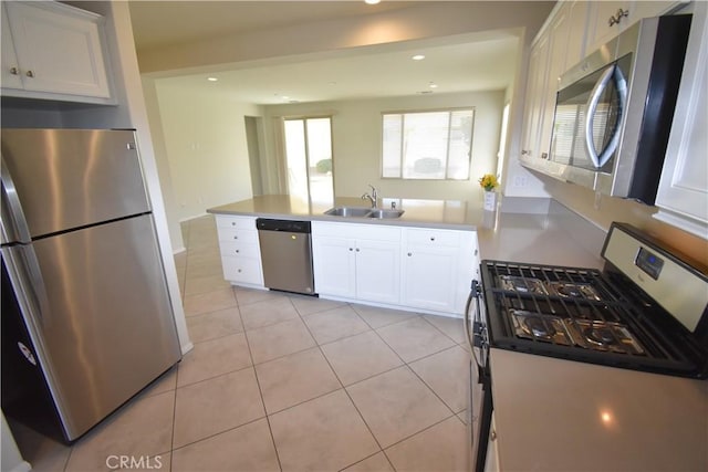 kitchen with sink, white cabinetry, and stainless steel appliances