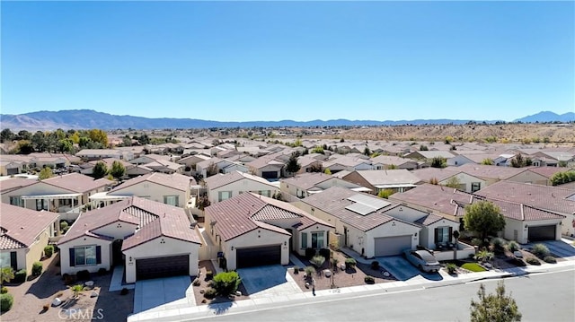 birds eye view of property featuring a mountain view