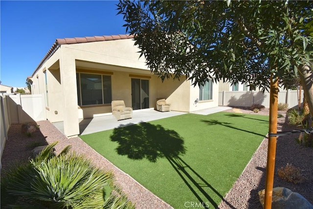 rear view of property with a patio area and a yard