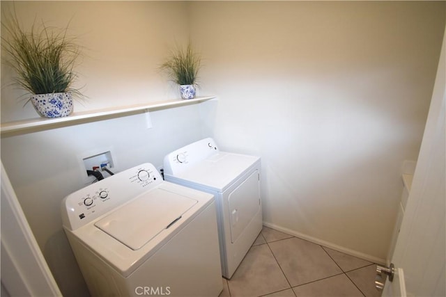 laundry room with light tile patterned flooring, laundry area, independent washer and dryer, and baseboards