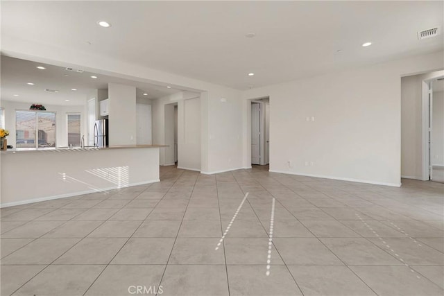 empty room with recessed lighting, visible vents, baseboards, and light tile patterned flooring