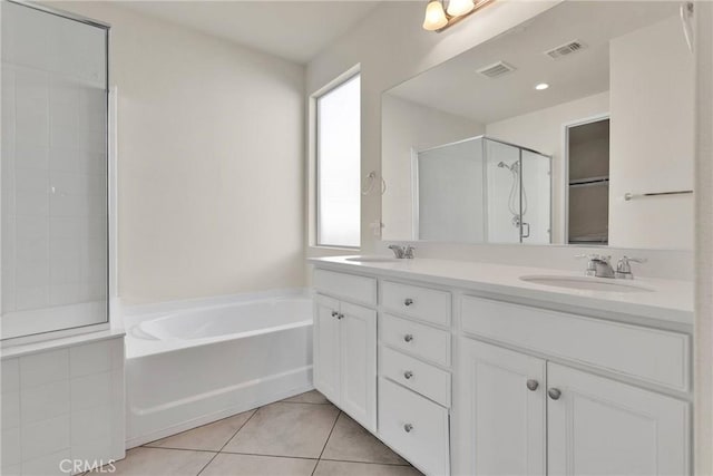 bathroom with tile patterned floors, visible vents, a shower stall, and a sink