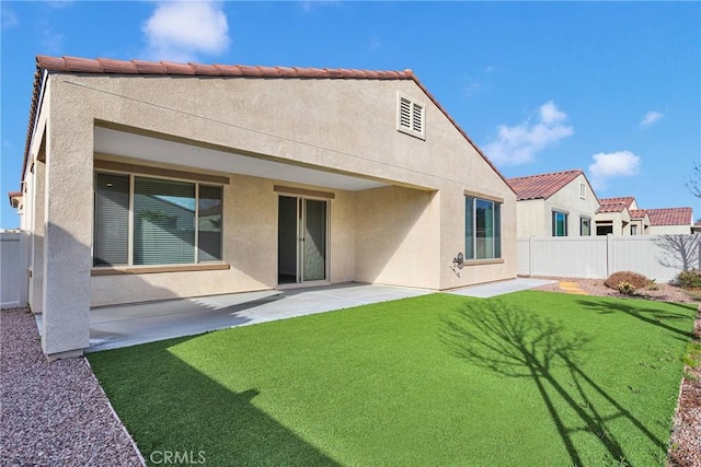 rear view of property with a patio area, stucco siding, and fence