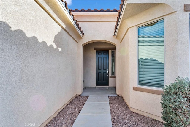 property entrance with stucco siding