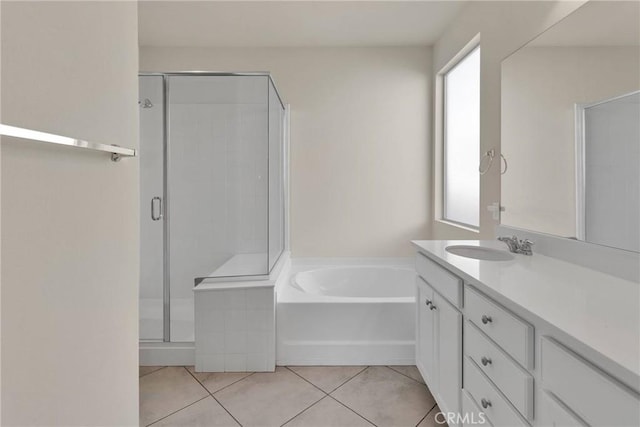 full bathroom featuring tile patterned floors, a stall shower, vanity, and a bath