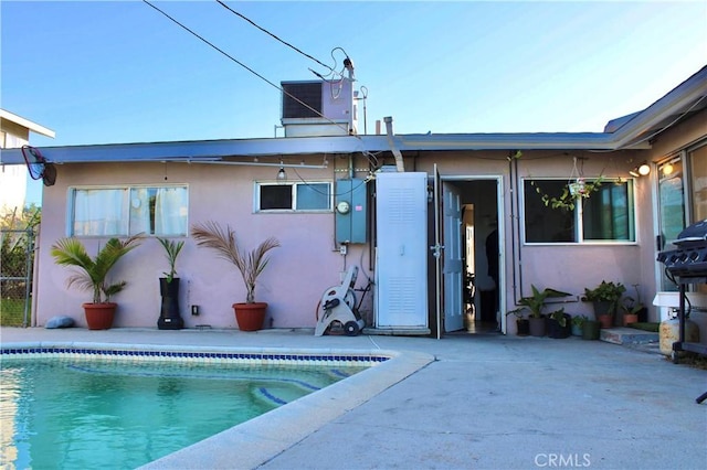 back of property with a patio area and central AC