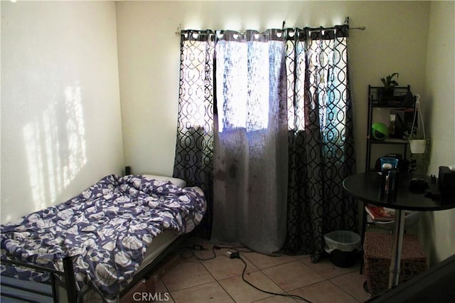 bedroom with light tile patterned floors