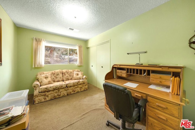 office area with light carpet and a textured ceiling