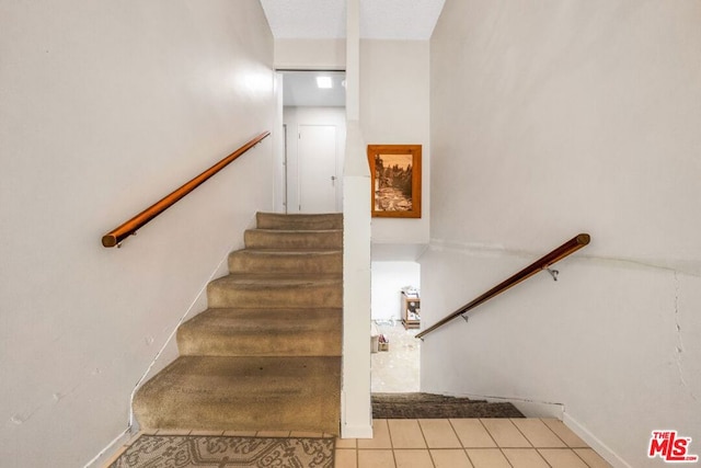 staircase featuring tile patterned floors