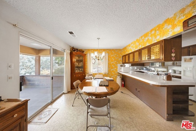 interior space featuring light carpet, a textured ceiling, and a chandelier