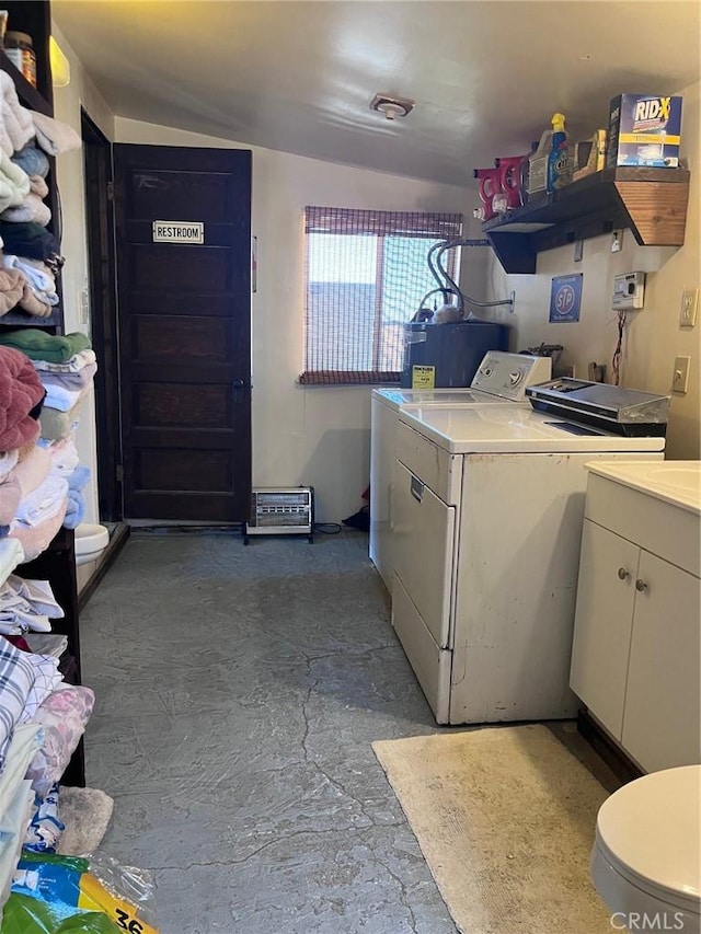 laundry room with washing machine and clothes dryer and water heater