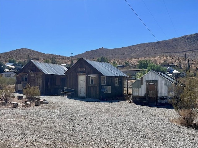 exterior space with a mountain view and an outbuilding