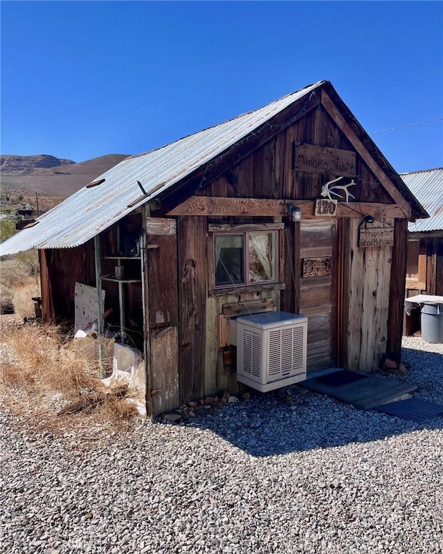 view of outbuilding featuring central AC unit and a mountain view