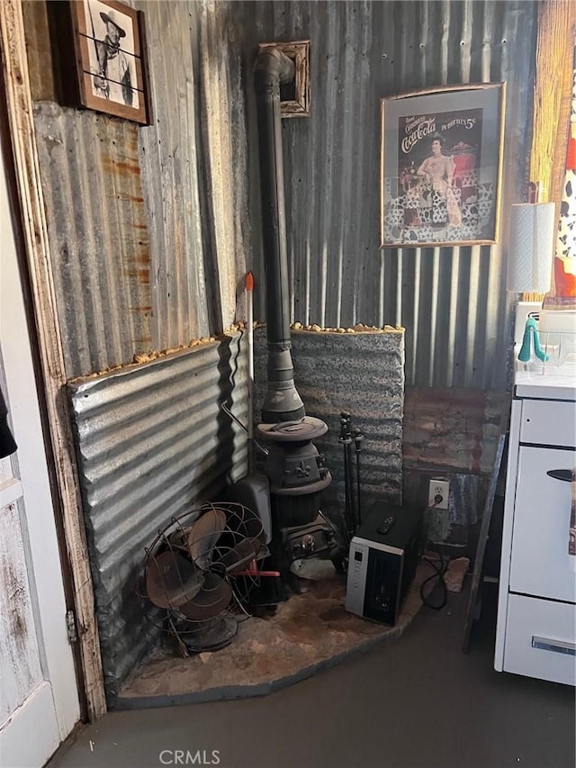 room details featuring a wood stove and concrete flooring