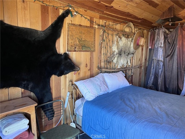 bedroom with wood walls and wood ceiling