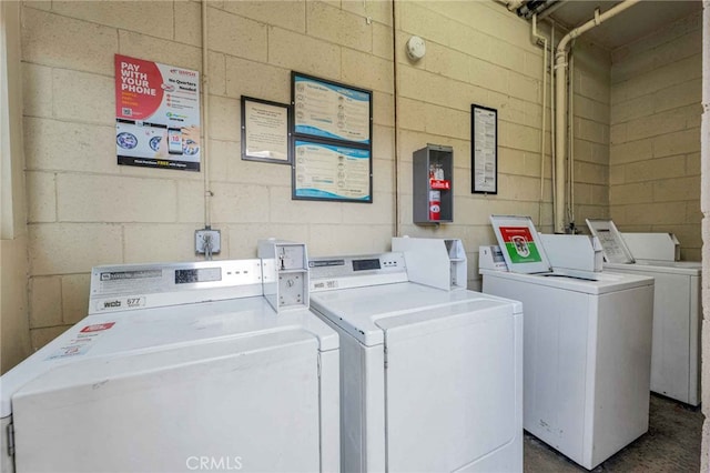 clothes washing area featuring independent washer and dryer