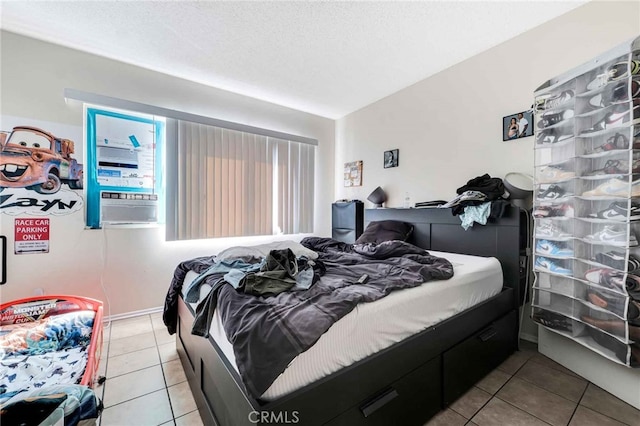 tiled bedroom with a textured ceiling