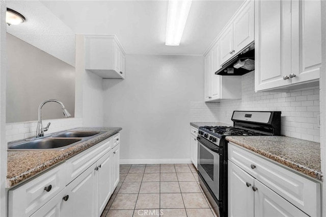 kitchen featuring gas range, sink, light tile patterned flooring, stone counters, and white cabinets