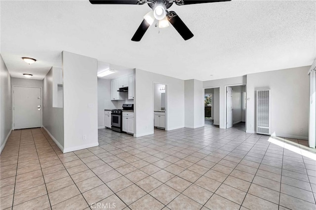 unfurnished living room with ceiling fan and light tile patterned flooring