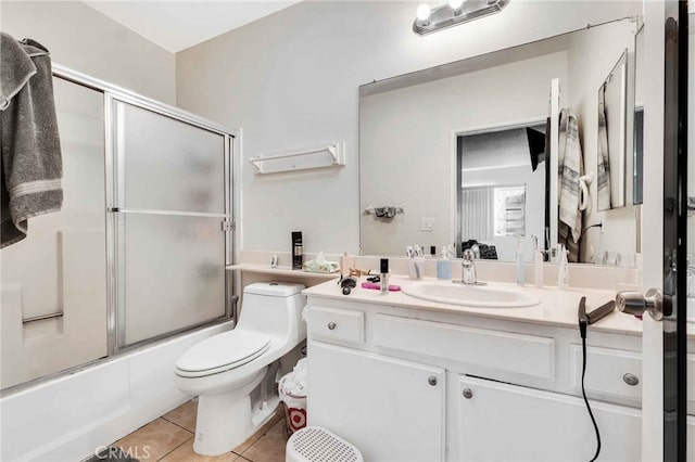 full bathroom with vanity, enclosed tub / shower combo, toilet, and tile patterned flooring