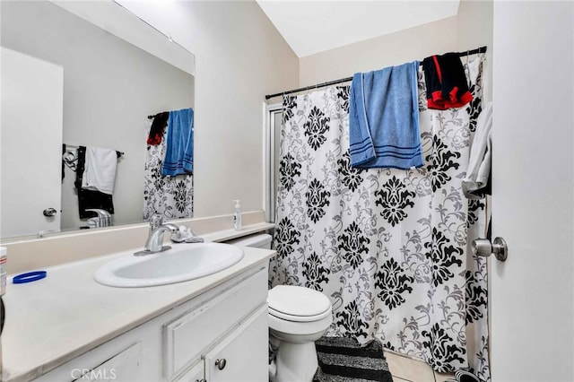 bathroom with vanity, toilet, and tile patterned flooring