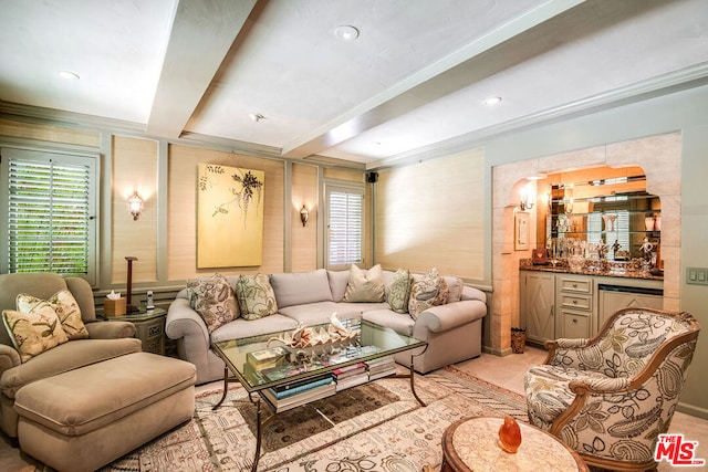 living room with beam ceiling and bar