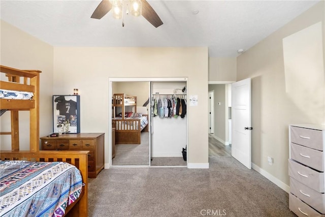 carpeted bedroom with ceiling fan and a closet