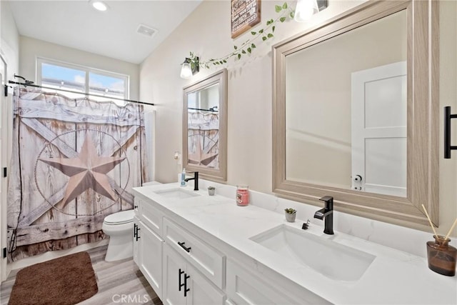 bathroom with a shower with shower curtain, vanity, hardwood / wood-style flooring, and toilet