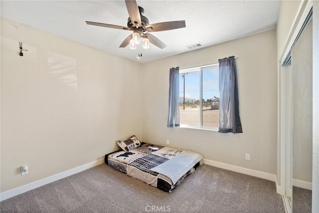 unfurnished bedroom with carpet, a closet, and ceiling fan