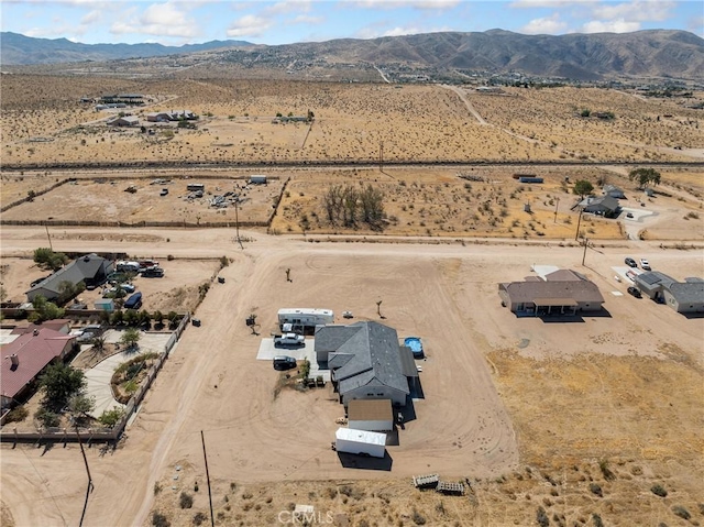 birds eye view of property with a mountain view