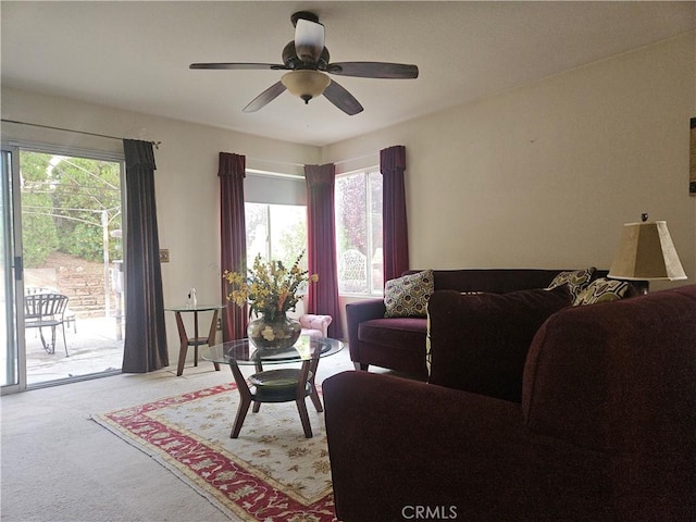 living room featuring light carpet and ceiling fan