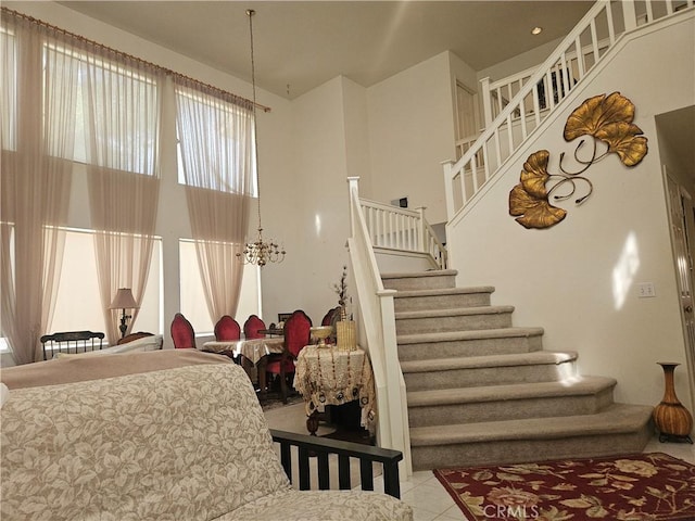 stairway featuring tile patterned flooring and a chandelier