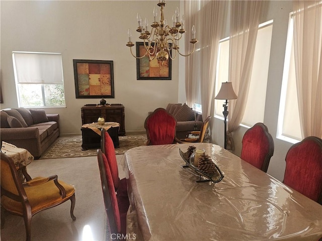 carpeted dining area featuring a chandelier