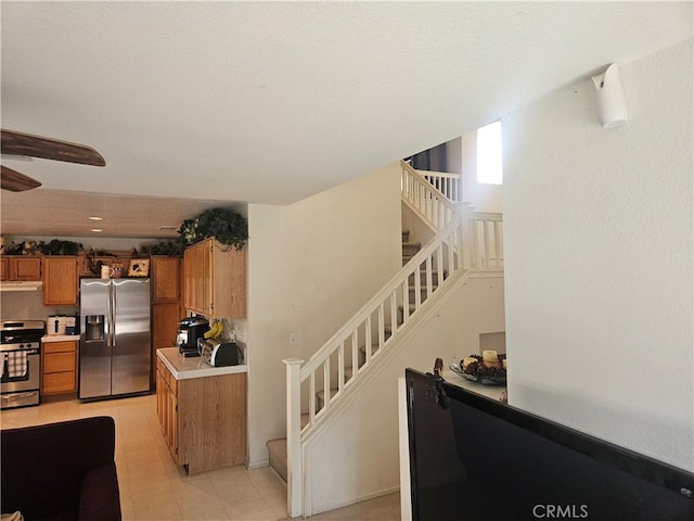 kitchen featuring appliances with stainless steel finishes and light tile patterned floors